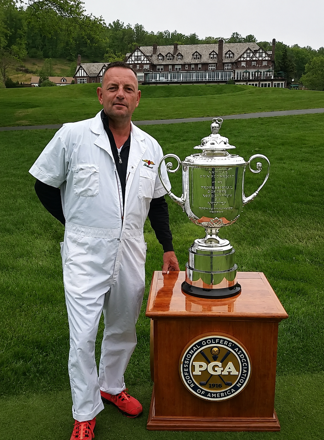 Our head designer standing with the PGA Championship trophy